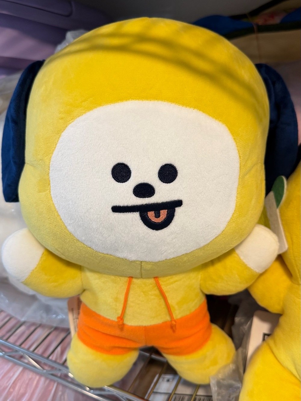 Yellow Cartoon Plush Character with Orange Shorts